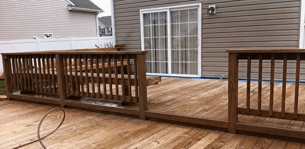 Deck sealing service protecting a backyard wood deck and railings in Rockford, IL