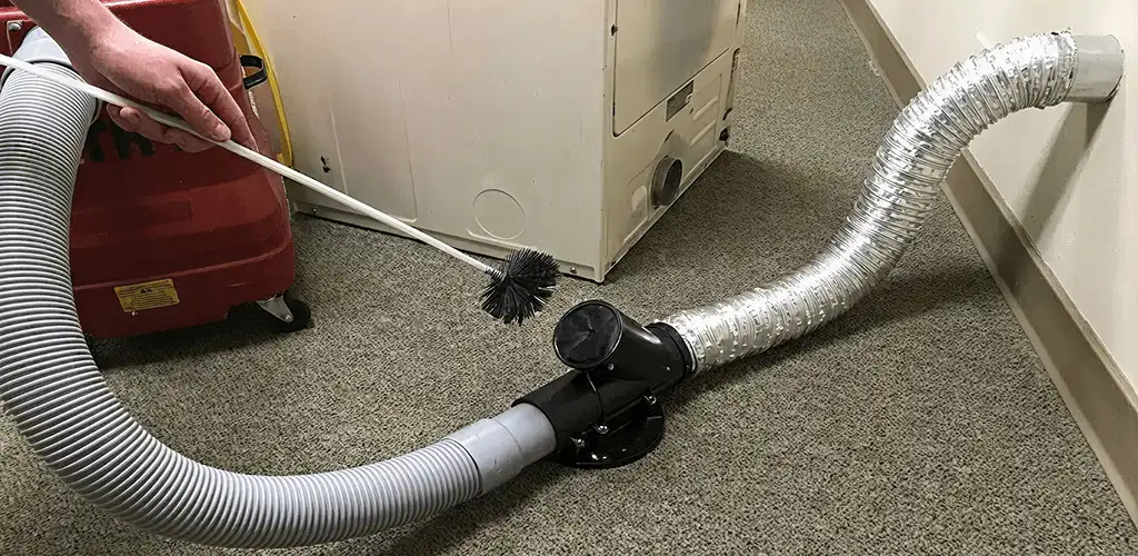 Dryer vent cleaning service removing lint from a dryer duct connection in Rockford, IL