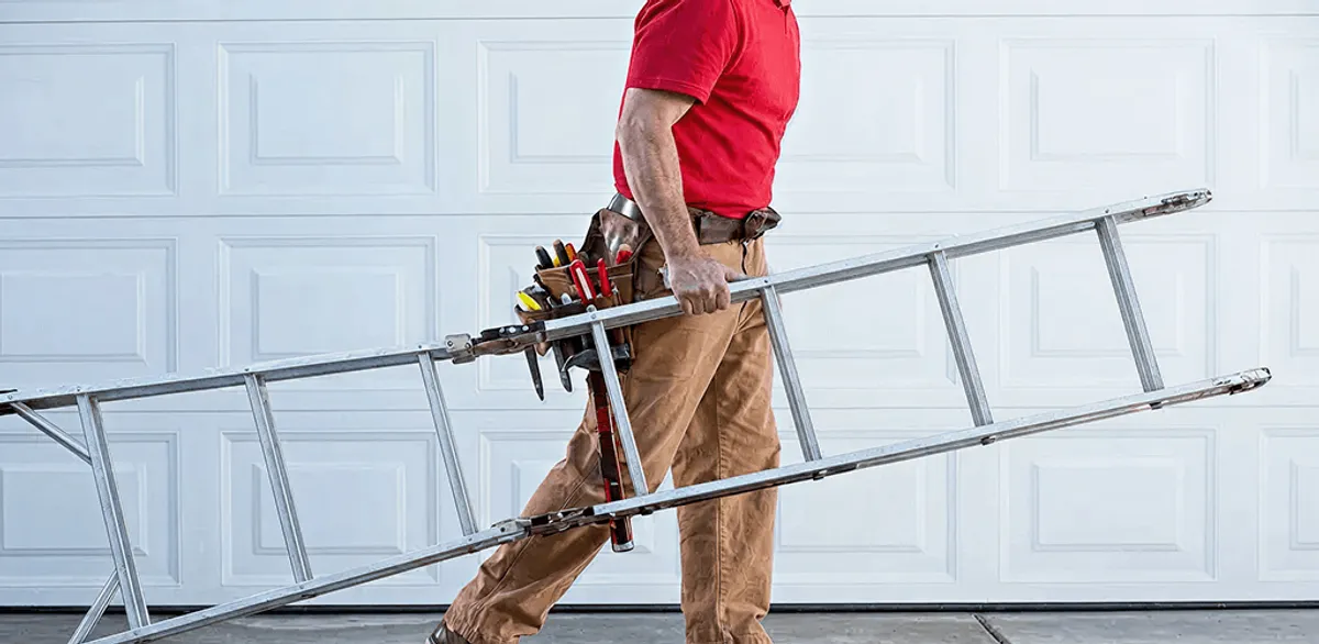 Garage door repair technician arriving with tools and ladder in Rockford, IL