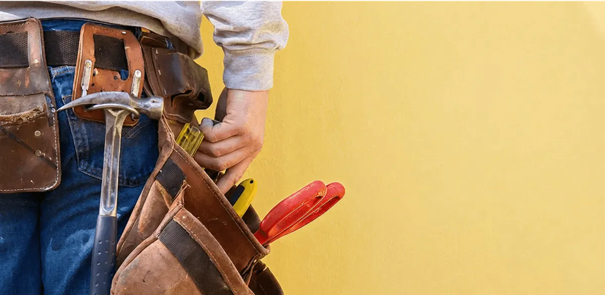 Handyman with tool belt ready for home repairs and maintenance in Rockford, IL
