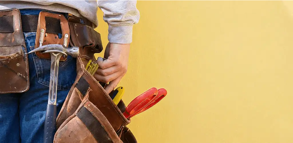 Handyman with tool belt ready for home repairs and maintenance in Rockford, IL