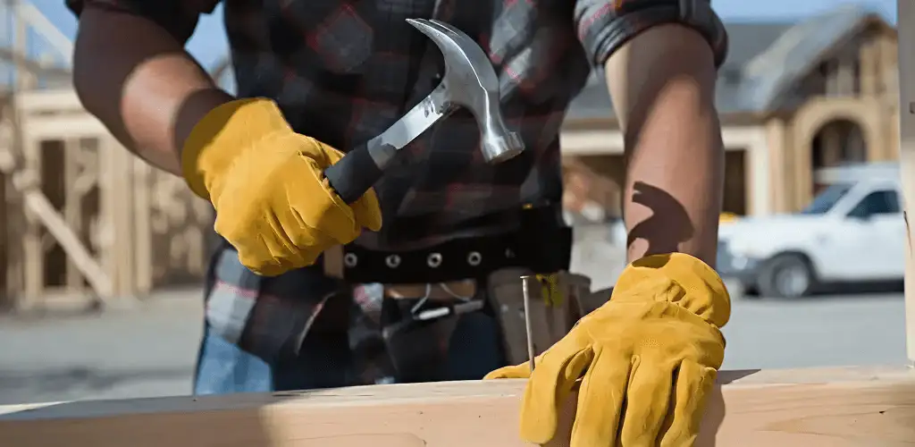Handyman fixing wood trim with a hammer for home repairs in Rockford, IL