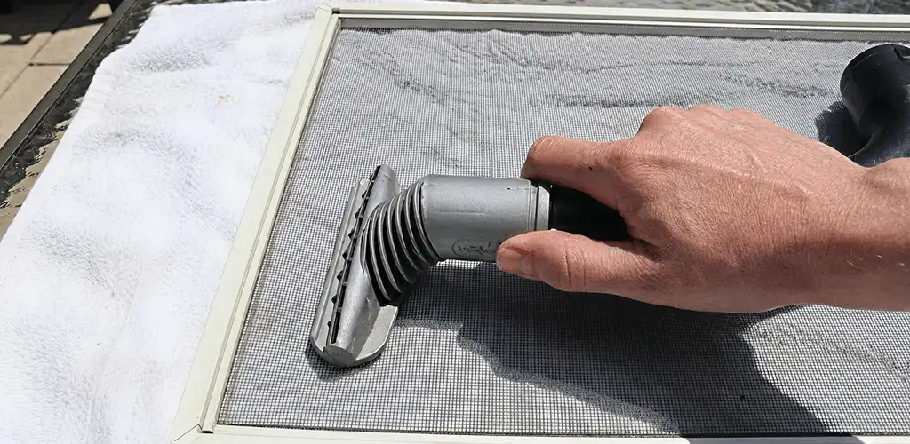 Window screen repair cleaning and fixing a damaged screen mesh in Rockford, IL
