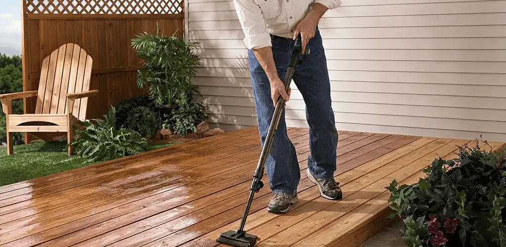 Deck staining service applying stain to a backyard wood deck in Rockford, IL